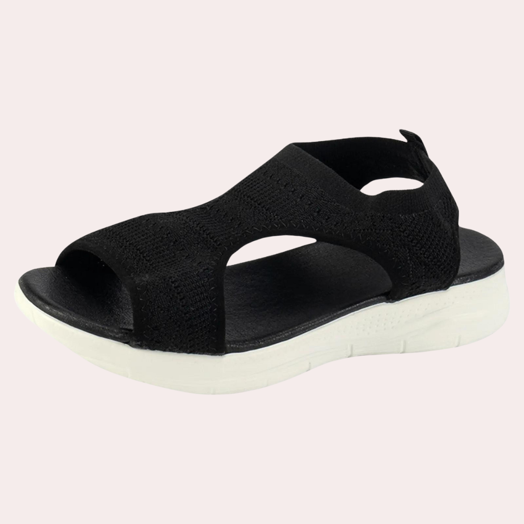 Zwarte dames sandaal met open teen, elastisch gebreid bovenwerk en witte zool. Comfortabele zomerschoen, ideaal voor casual en dagelijks gebruik.