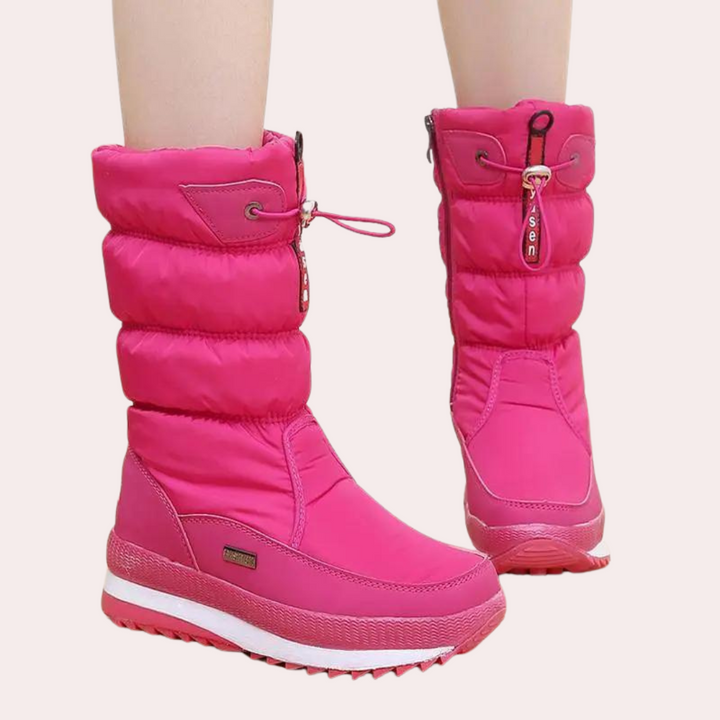 Roze winterlaarzen voor dames met gewatteerde schacht, ritssluiting en stevige zool. Perfect voor koude weersomstandigheden en modieuze uitstraling.