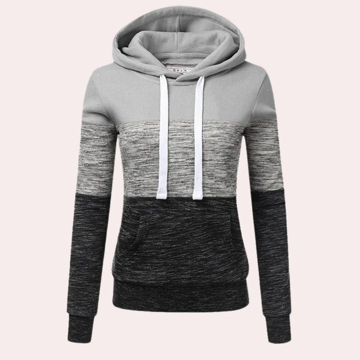 Grijze dameshoodie met capuchon, kleurblokken en buidelzak. Comfortabele sweater, ideaal voor casual outfits. Perfect voor herfst en winter.