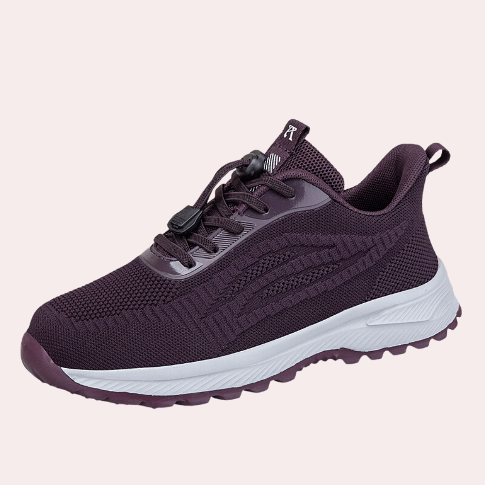 Paarse sportschoen met witte zool, ademend mesh bovenwerk, vetersluiting en logo. Ideaal voor hardlopen en fitness. Comfortabele en stijlvolle sneaker.