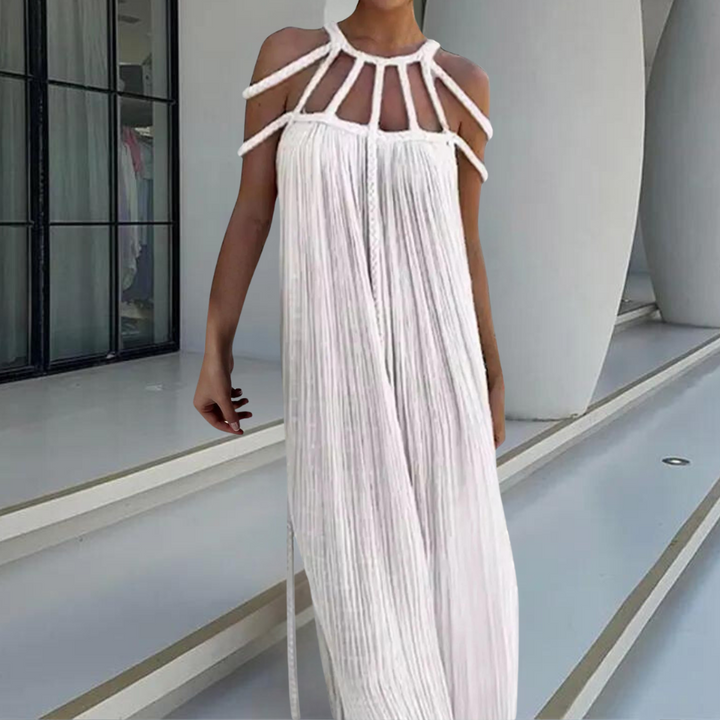 Witte maxi-jurk met plooien en unieke schouderbanden, perfect voor zomerse evenementen. Elegant design, luchtige stof, trendy mode.