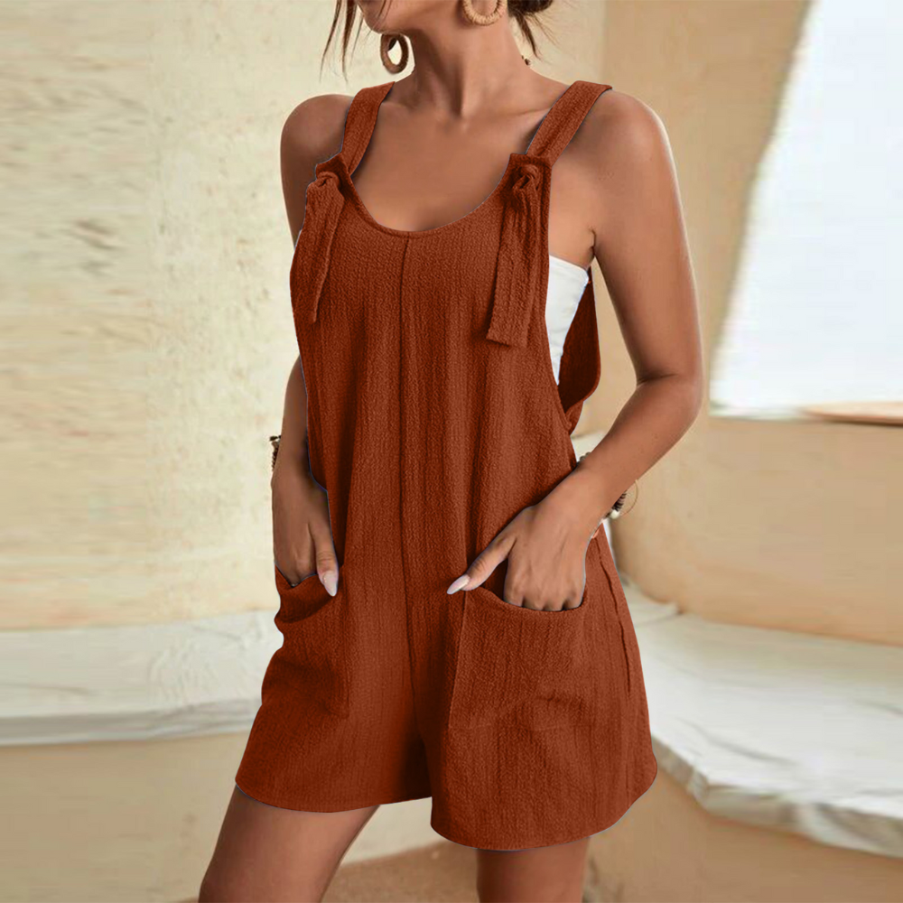 Vrouw in bruine, mouwloze zomerjurk met zakken, casual en stijlvol, perfect voor warme dagen. Trendy damesmode, comfortabele pasvorm.