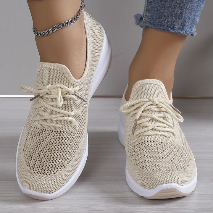 Lichtgele dames sneakers met ademend mesh, vetersluiting en witte zool, gedragen met jeans. Comfortabele en modieuze schoenen voor dagelijks gebruik.