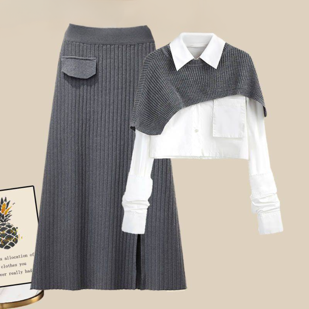 Grijze geribbelde rok en witte blouse met grijze schoudercape, stijlvolle dameskleding, modieuze herfstoutfit, elegante en moderne look.