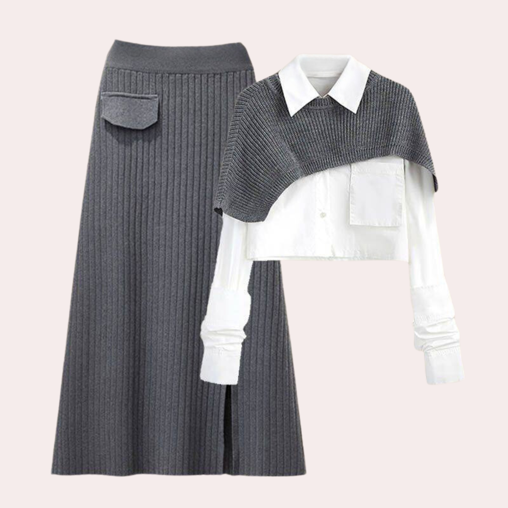 Grijze geribbelde rok en witte blouse met grijze schoudercape, stijlvolle dameskleding, modieuze herfstoutfit, elegante zakelijke look.