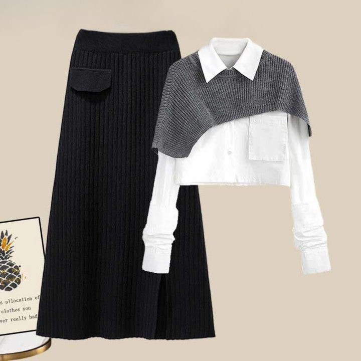 Grijze en zwarte damesoutfit met geribbelde rok en cropped trui over witte blouse. Modieuze herfstkleding, stijlvolle damesmode.