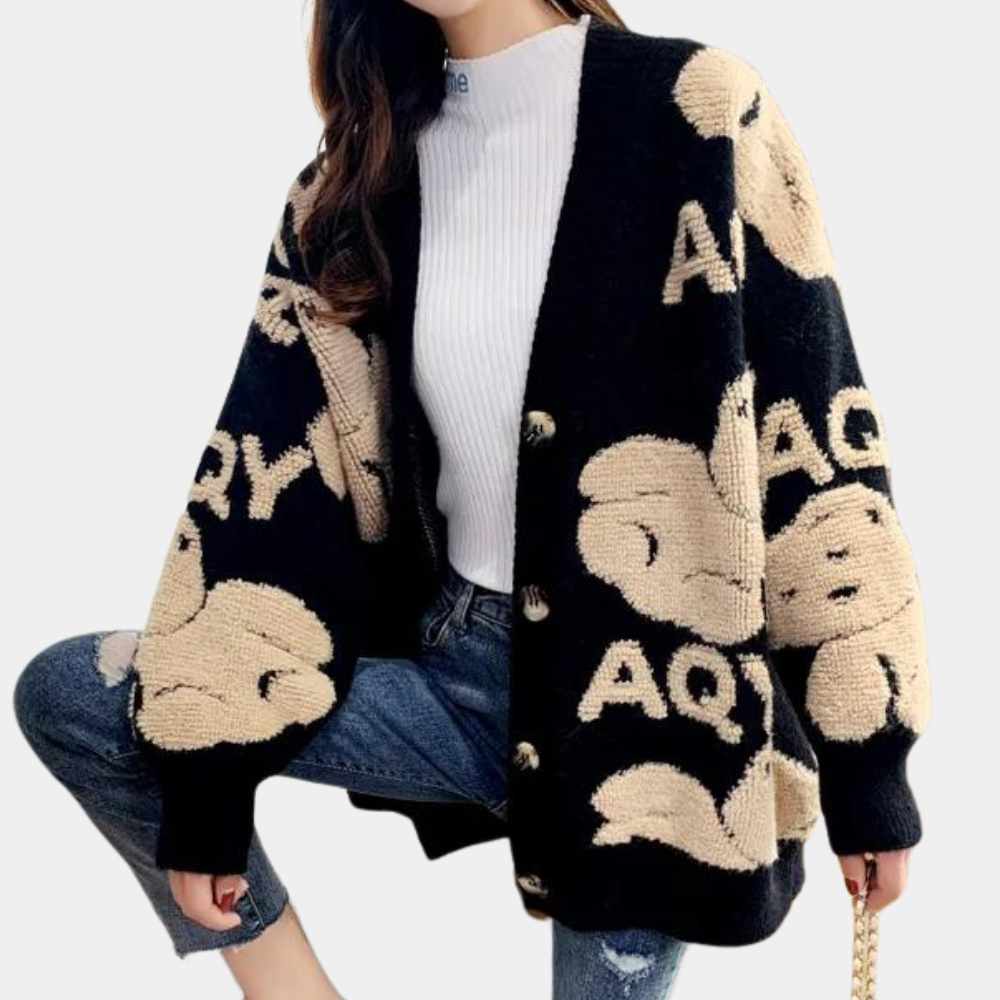 Zwarte oversized cardigan met beige abstracte patronen, lange mouwen en knopen. Trendy damesmode, perfect voor casual herfst- en winteroutfits.