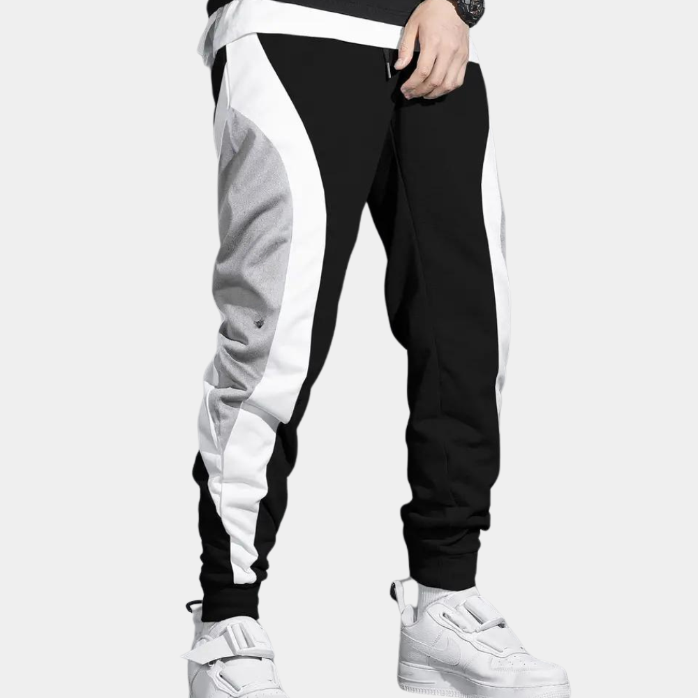 Zwart-witte joggingbroek voor heren met grijze accenten, sportief design, comfortabele pasvorm, ideaal voor casual en sportieve activiteiten.