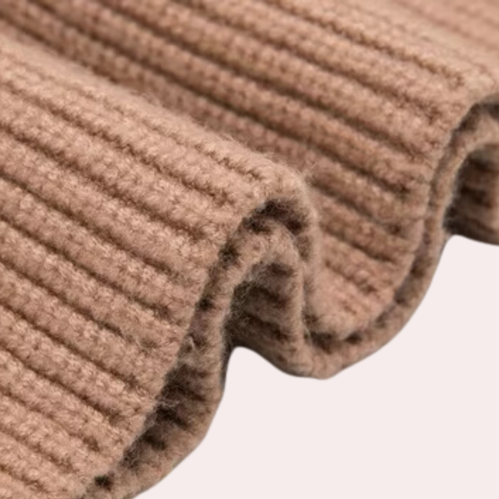 Geribbelde beige wollen stof close-up, zachte textuur, geschikt voor winterkleding en breiprojecten. Hoogwaardige wol, duurzaam en warm.