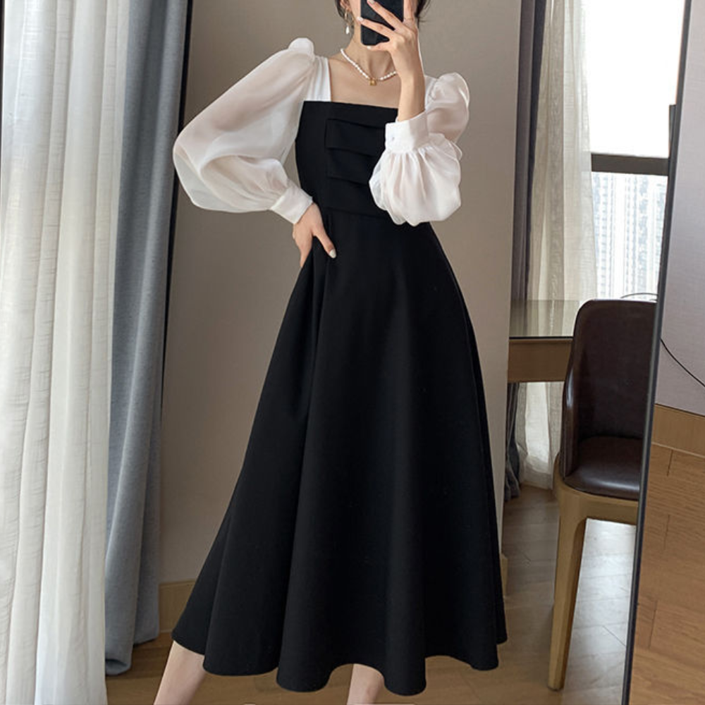 Elegante zwarte jurk met pofmouwen en vierkante halslijn, perfect voor formele gelegenheden. Stijlvolle damesmode, tijdloze avondjurk.