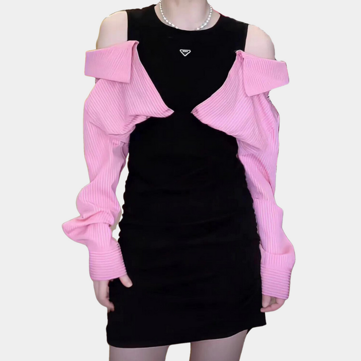 Zwarte jurk met roze ribgebreide schouderbedekking, trendy damesmode, elegante avondkleding, moderne stijl, perfecte outfit voor speciale gelegenheden.