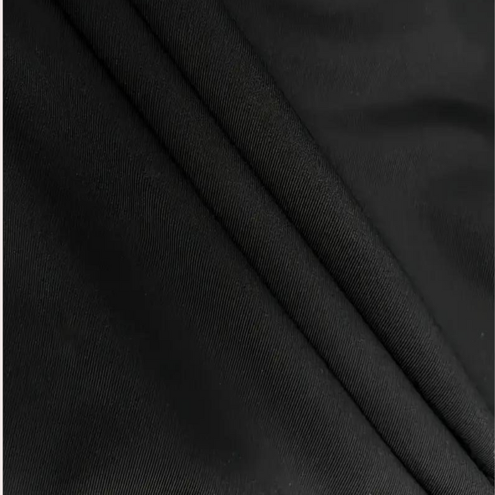 Zwarte stof close-up, gladde textuur, geschikt voor kleding en interieur. Hoogwaardige textielmaterialen, duurzaam en stijlvol design.
