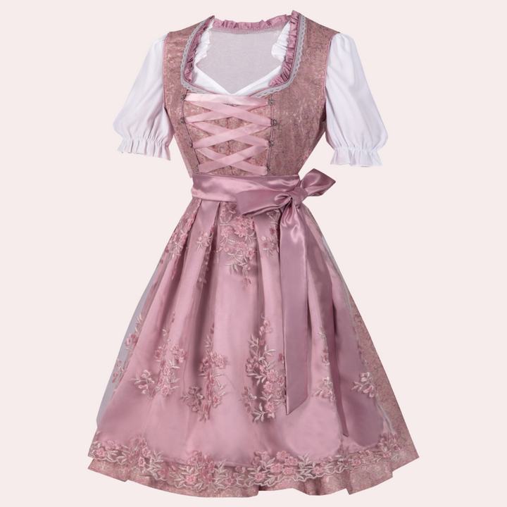 Roze dirndl jurk met geborduurde bloemen, witte blouse en satijnen strik. Traditionele Beierse kleding, perfect voor Oktoberfest en themafeesten.