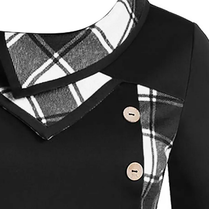 Zwart damesjurkdetail met geruite kraag en knopen. Elegante mode, stijlvolle kleding, trendy design, hoogwaardige stof. Perfect voor elke gelegenheid.