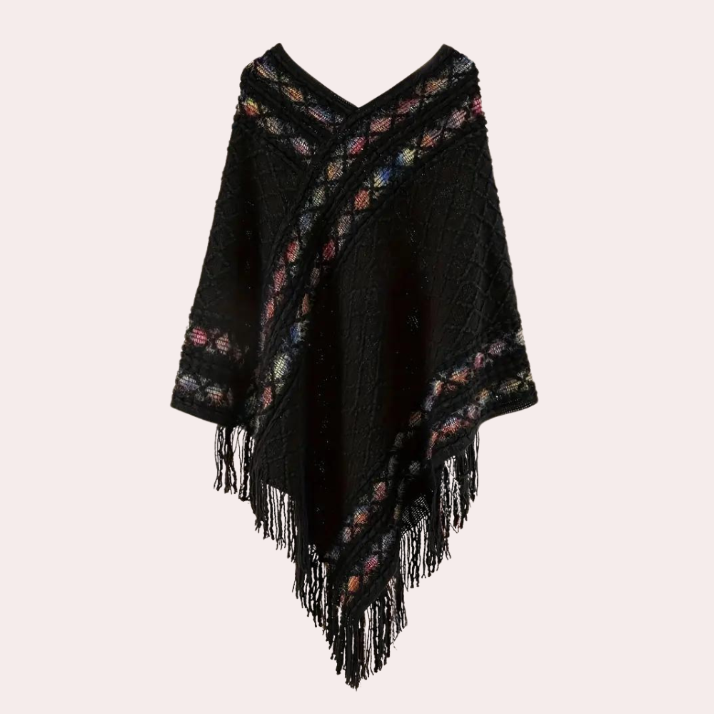 Zwarte gebreide poncho met kleurrijke strepen en franjes, damesmode, herfst-winter kleding, stijlvolle warme omslagdoek.