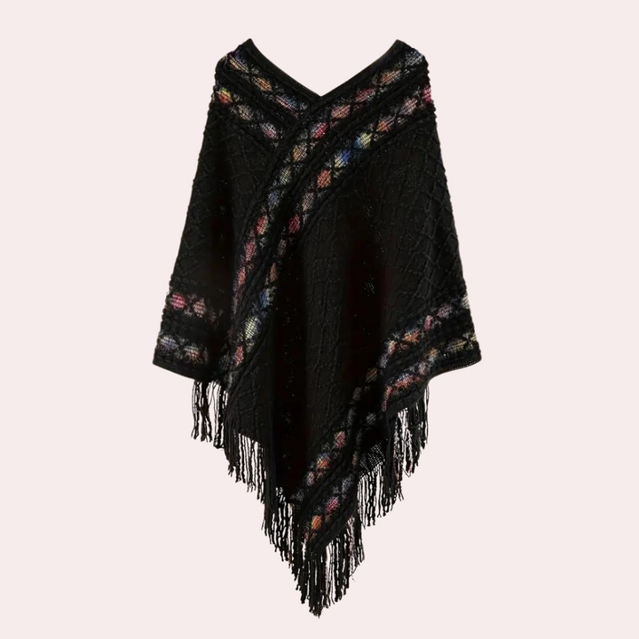 Zwarte gebreide poncho met kleurrijke strepen en franjes, damesmode, herfst-winter kleding, stijlvolle warme omslagdoek.