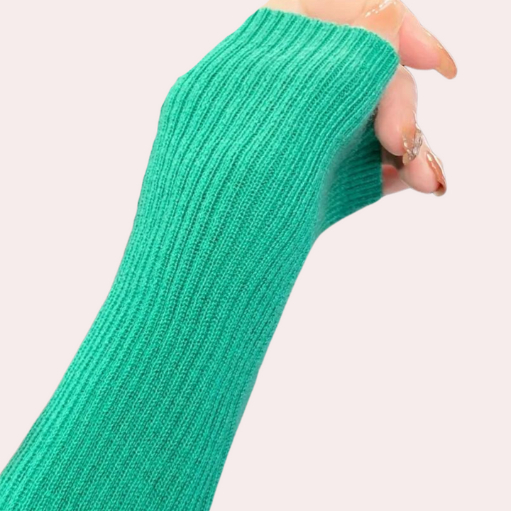 Groene gebreide handschoen met ribbelpatroon, gedragen door een hand. Modieuze winteraccessoire, ideaal voor koude dagen. Comfortabel en stijlvol.
