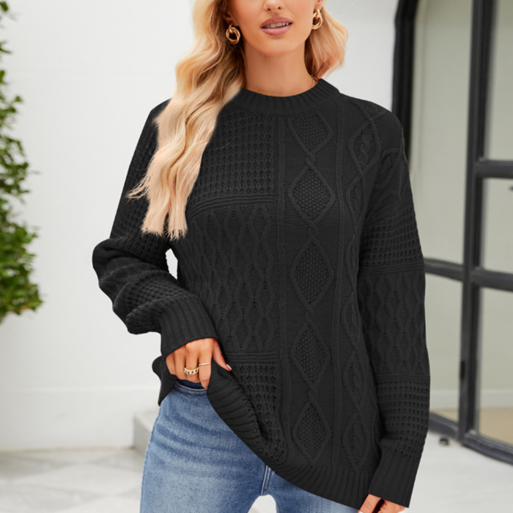 Vrouw draagt zwarte kabeltrui, casual outfit, lange mouwen, modieuze herfstkleding, buiten, blonde haren, moderne stijl, comfortabele pasvorm.