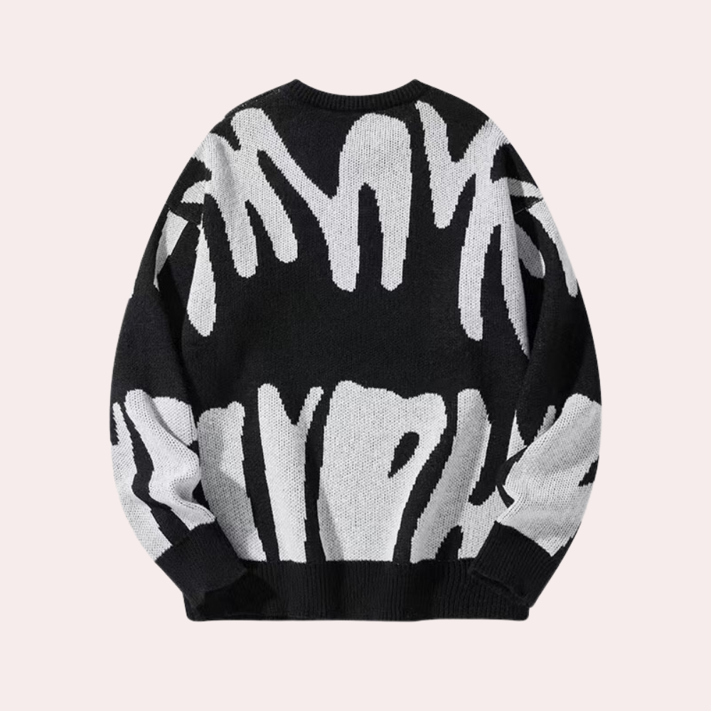 Zwart-witte oversized trui met abstract patroon, unisex design, gebreid van katoenmix. Perfect voor casual herfst- en wintermode.