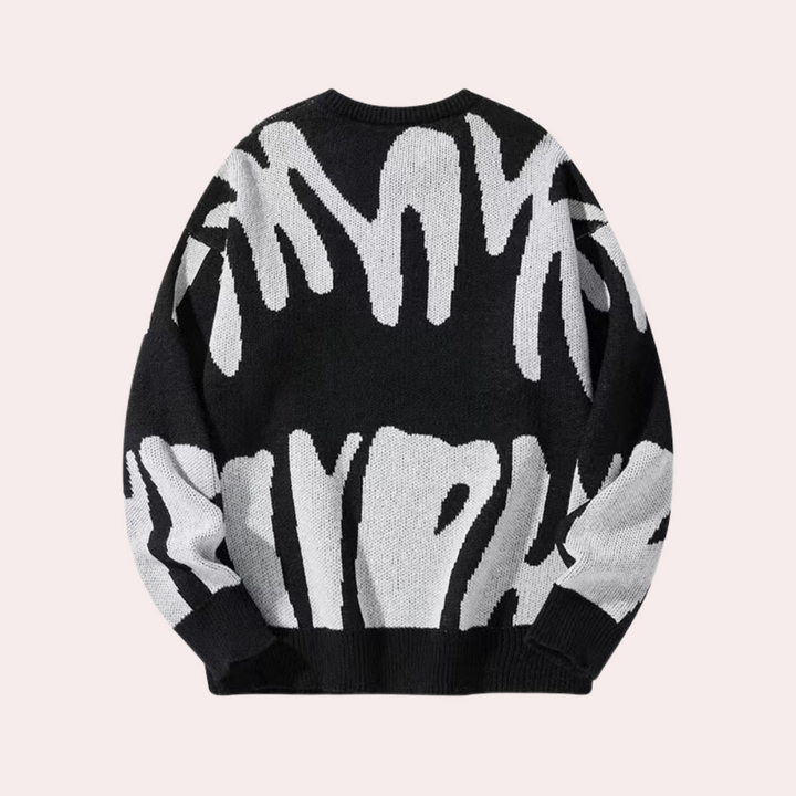 Zwart-witte oversized trui met abstract patroon, unisex design, gebreid van katoenmix. Perfect voor casual herfst- en wintermode.