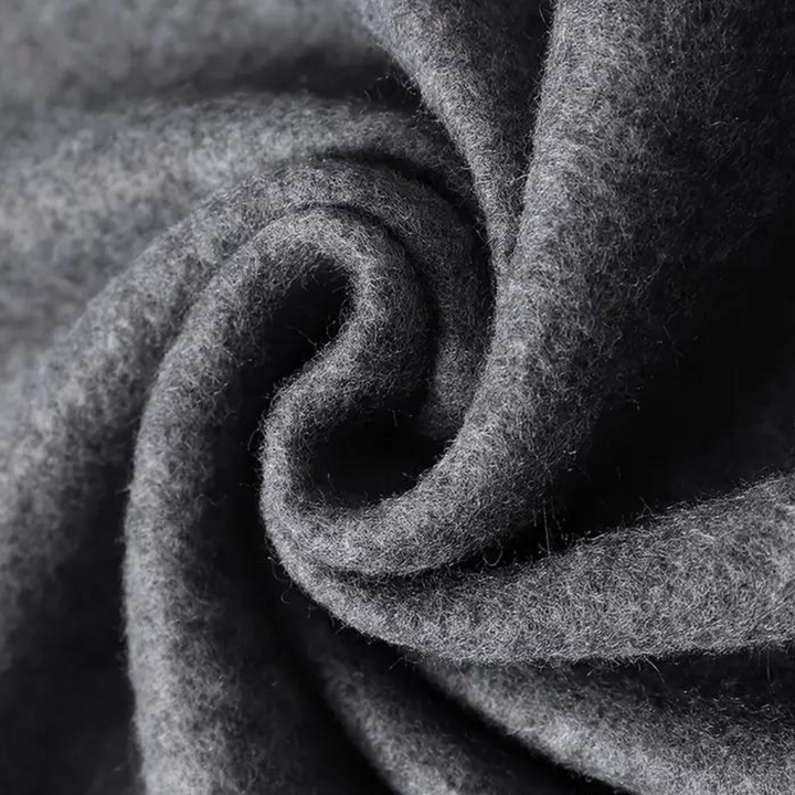 Grijze wollen stof close-up, gedetailleerde textuur, zachte en warme uitstraling, ideaal voor winterkleding en interieurdecoratie.