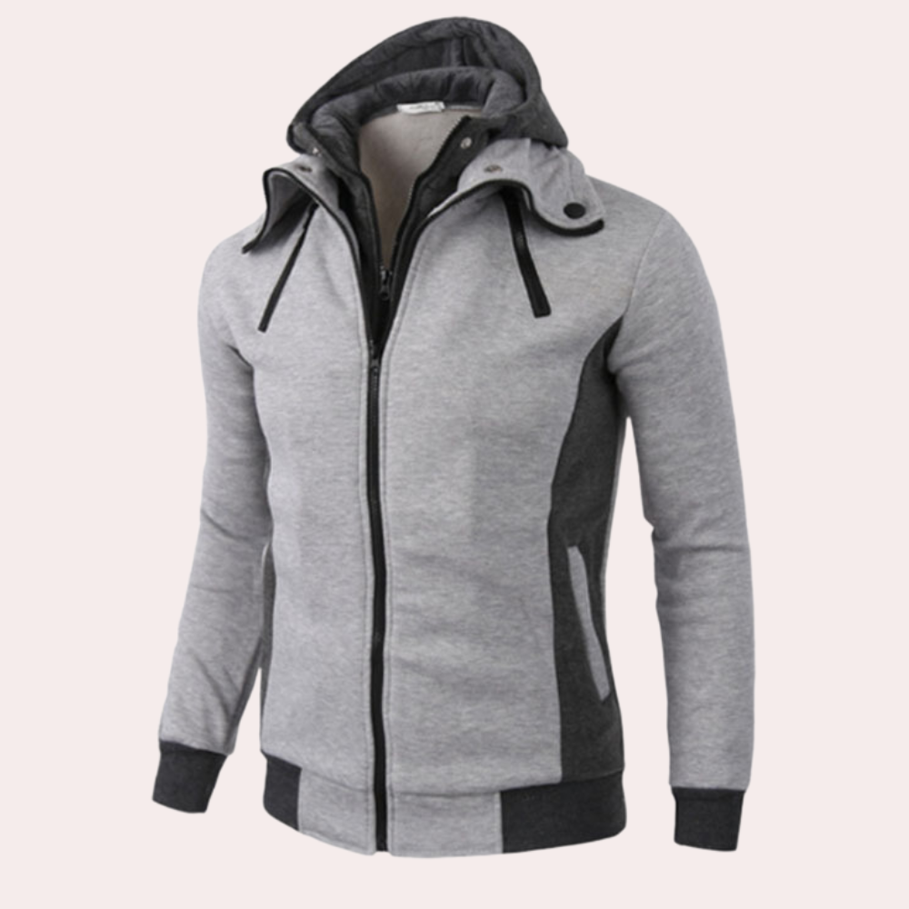 Grijze heren hoodie met capuchon, ritssluiting en zwarte accenten. Comfortabele sportkleding, ideaal voor casual en actieve outfits.