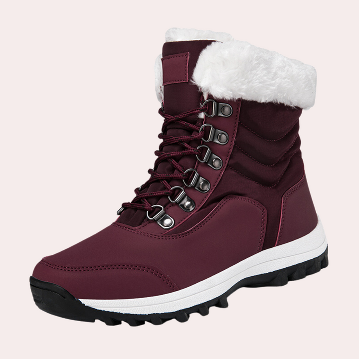 Rode winterlaars met witte bontkraag, stevige zool en metalen veterogen. Ideaal voor dames, warme en modieuze sneeuwlaars.