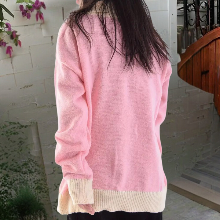 Roze damestrui met lange mouwen, gedragen door model, tegen een neutrale achtergrond. Perfect voor casual herfst- en winteroutfits.
