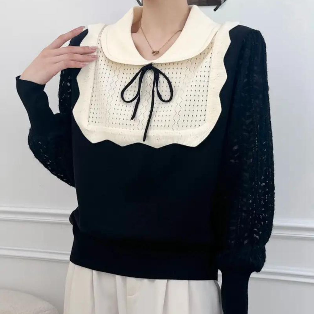 Zwarte trui met witte kraag en strik, gehaakte details op borst en mouwen, damesmode, elegante kleding, herfst-winter stijl.