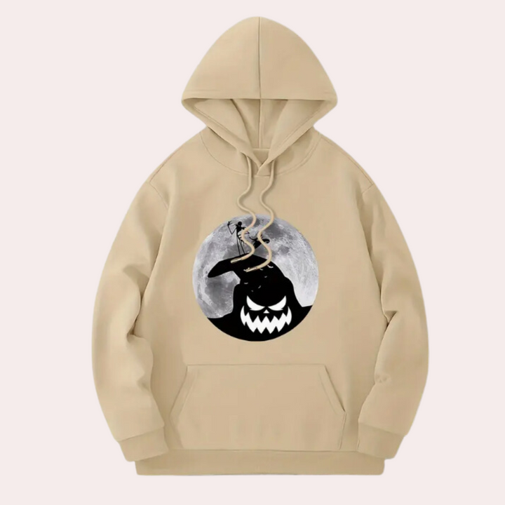 Beige hoodie met Halloween-print, featuring een grijnzende zwarte figuur en volle maan. Comfortabele unisex trui, perfect voor herfstmode.