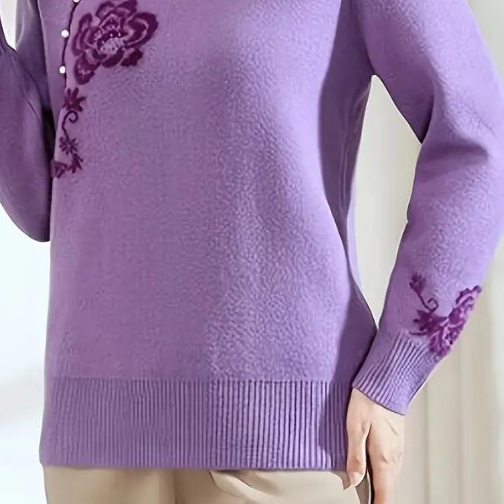 Paarse damestrui met bloemenborduursel, lange mouwen en ronde hals. Modieuze gebreide trui voor herfst en winter. Comfortabele pasvorm.