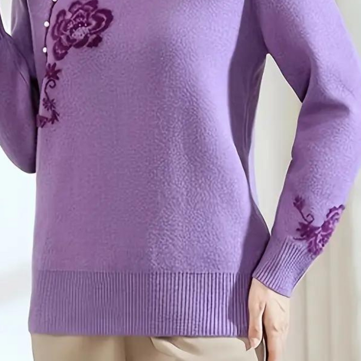 Paarse damestrui met bloemenborduursel, lange mouwen en ronde hals. Modieuze gebreide trui voor herfst en winter. Comfortabele pasvorm.