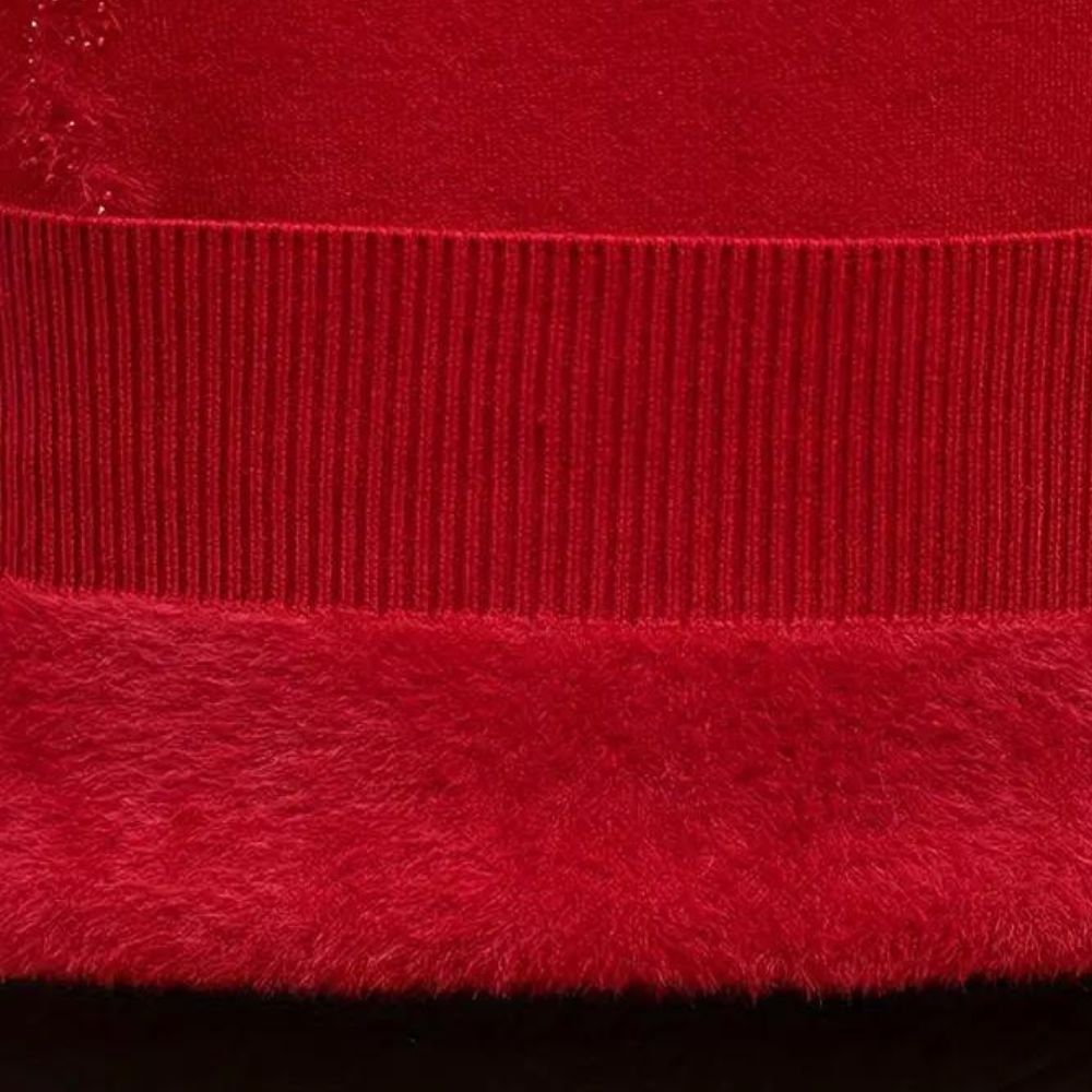 Rode trui detail met geribde zoom en zachte textuur. Hoogwaardige stof, warme wintermode, stijlvolle kleding. Perfect voor koude dagen.