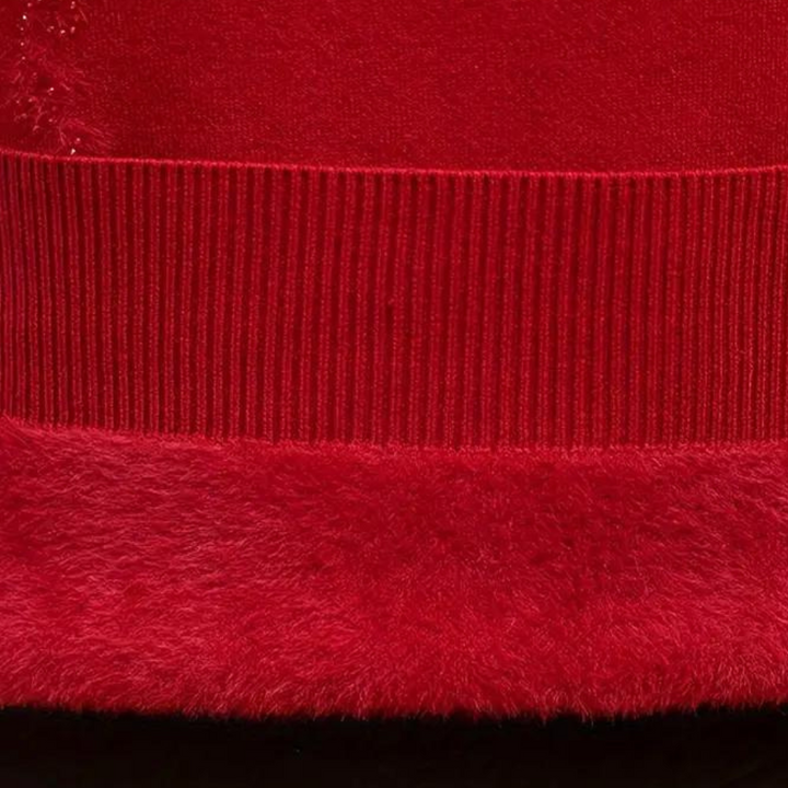 Rode trui detail met geribde zoom en zachte textuur. Hoogwaardige stof, warme wintermode, stijlvolle kleding. Perfect voor koude dagen.