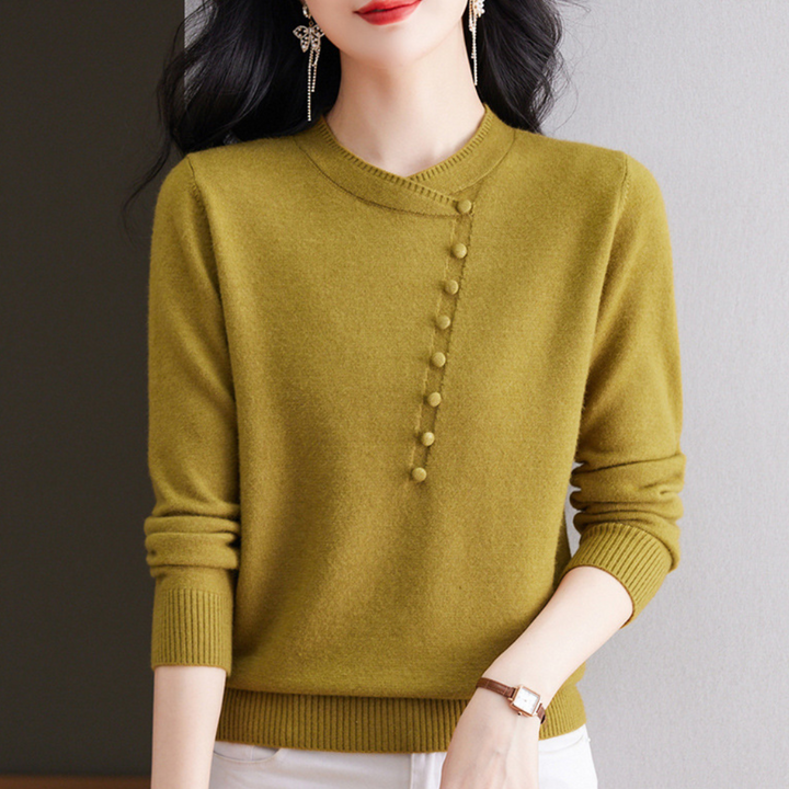 Vrouw in olijfgroene trui met knoopdetails, lange mouwen en ronde hals. Modieuze dameskleding, herfststijl, casual elegantie.