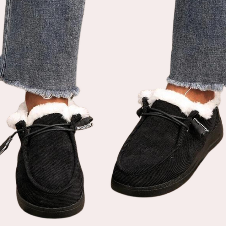 Zwarte corduroy schoenen met witte voering, gedragen met gerafelde jeans. Comfortabele wintermode, casual stijl, warme voering.