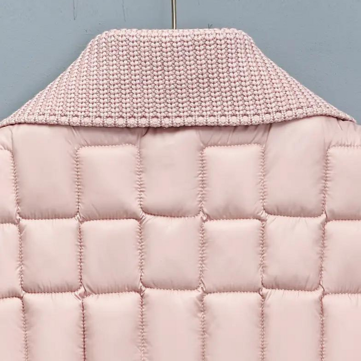Roze gewatteerde jas met gebreide kraag, detailopname. Modieuze winterjas, warme kleding, trendy damesmode, stijlvolle jas.