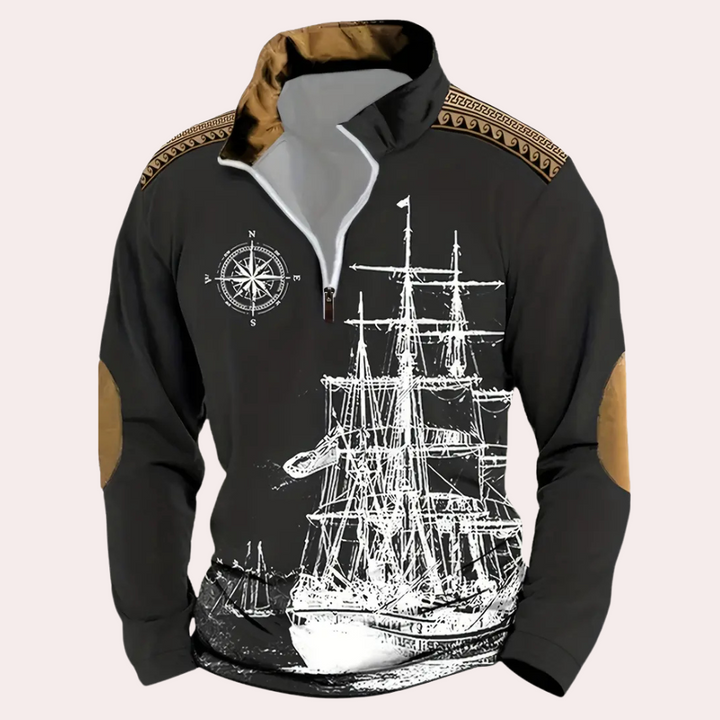 Zwarte herensweater met witte scheepsprint, kompasontwerp en bruine elleboogstukken. Modieuze nautische kleding, ideaal voor casual herenkleding.