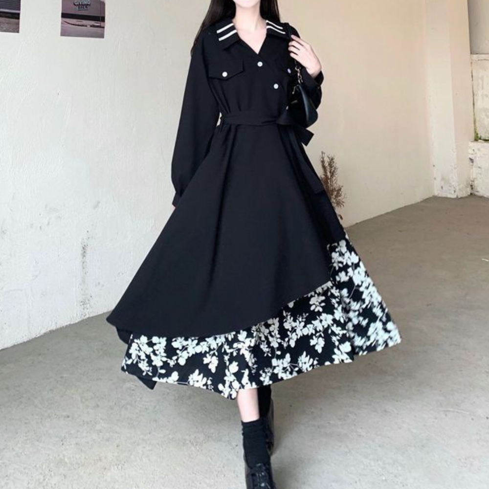 Zwarte Marusia-jurk met witte bloemenprint, lange mouwen en kraagdetails. Elegante damesmode, perfect voor herfst- en winterseizoenen.