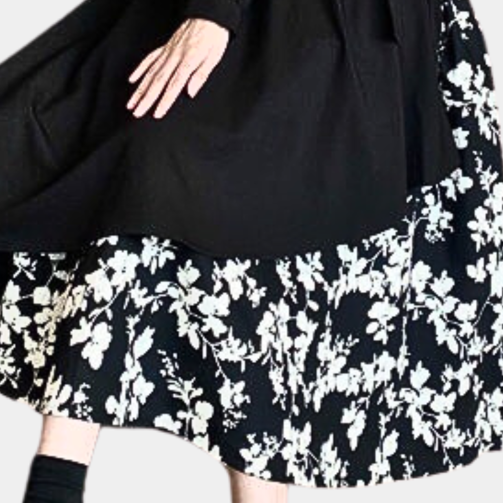 Zwart-witte bloemenrok, vloeiend ontwerp, elegante damesmode, Marusia-collectie, hoogwaardige stof, stijlvolle kleding, trendy outfit.