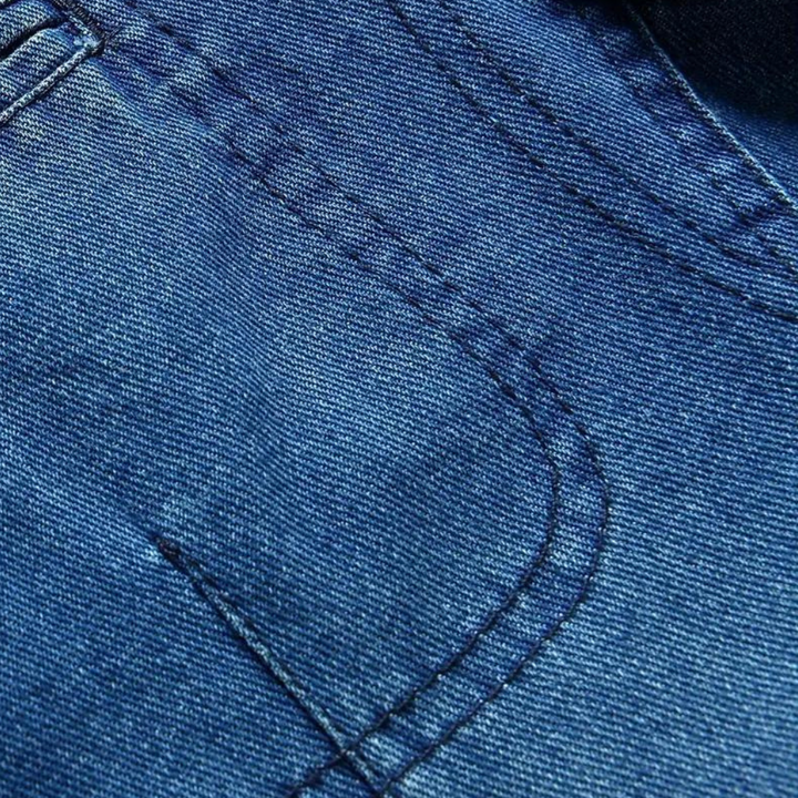 Blauwe denimstof close-up met zichtbare stiksels en textuur, ideaal voor mode, jeans, en kledingontwerp. Hoogwaardige jeansstof detail.