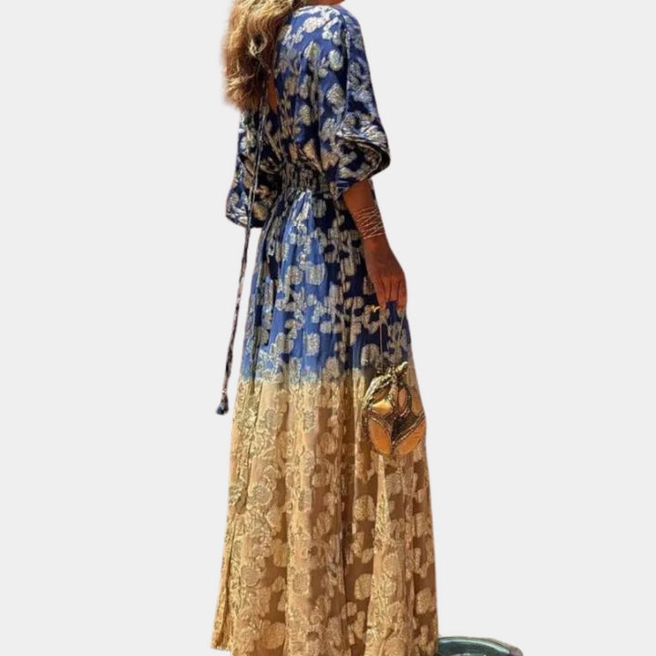 Stijlvolle damesjumpsuit met blauwe en beige bloemenprint, lange mouwen en ceintuur. Perfect voor modieuze zomerse outfits.