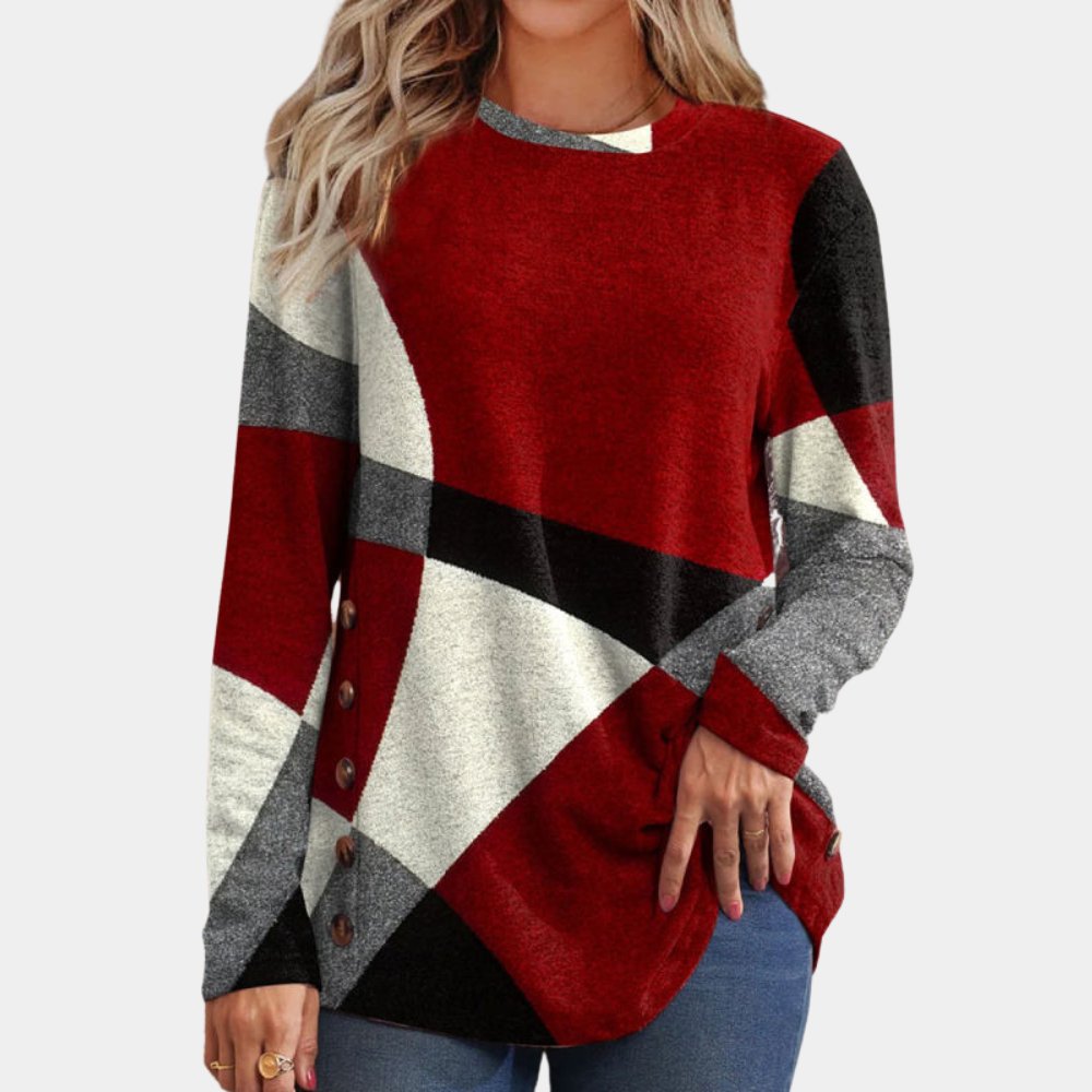 Damestrui met lange mouwen, geometrisch patroon in rood, zwart, wit en grijs, knoopdetails aan de zijkant. Modieuze herfstkleding.