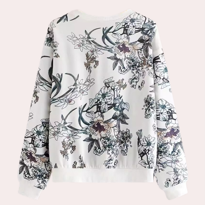Witte damestrui met bloemenprint, lange mouwen en ronde hals. Modieuze casual kleding, ideaal voor lente en herfst. Comfortabele pasvorm.