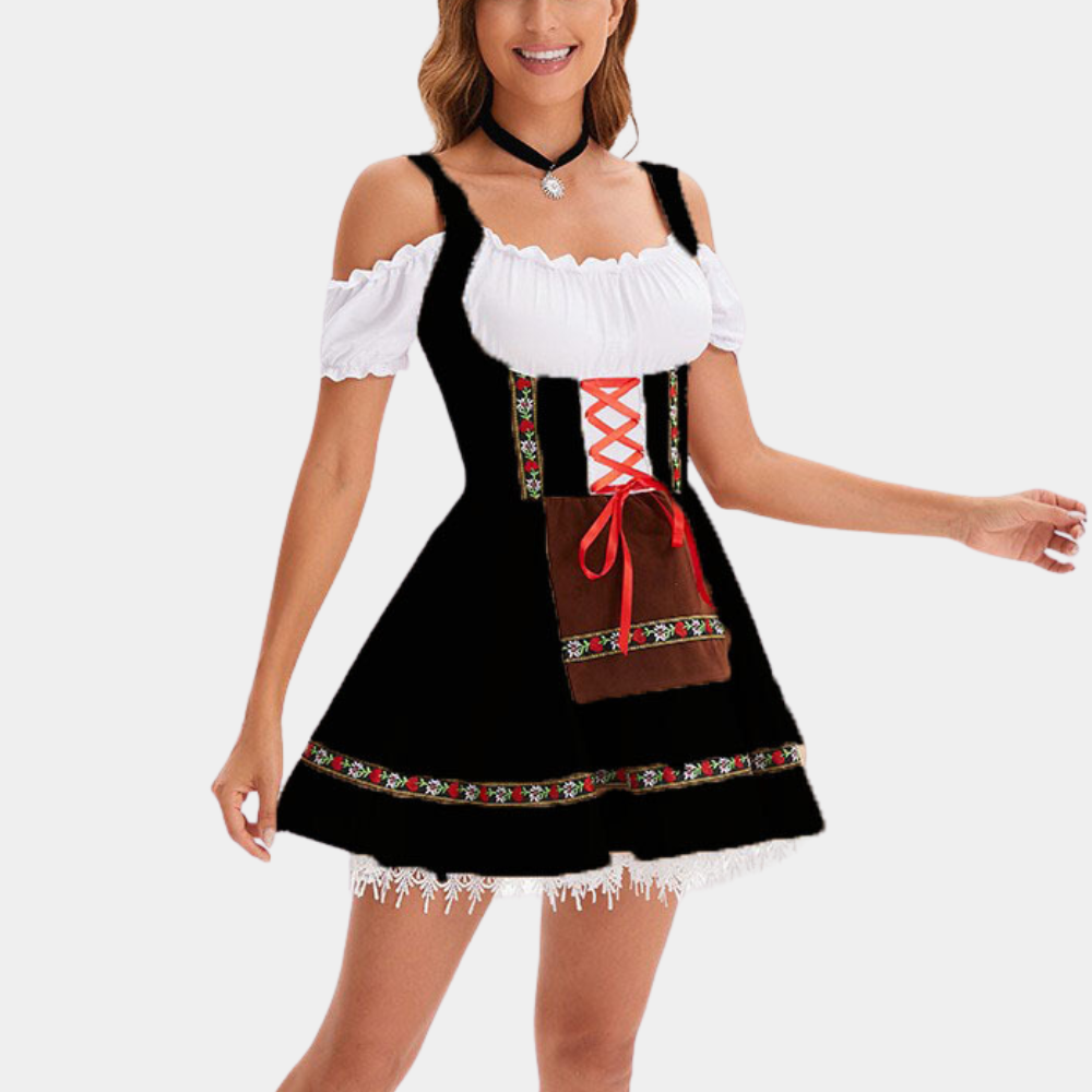 Vrouw in elegante dirndl jurk voor Oktoberfest, met zwart lijfje, witte blouse, rode veter en bloemenpatroon. Perfect voor traditionele Duitse feesten.