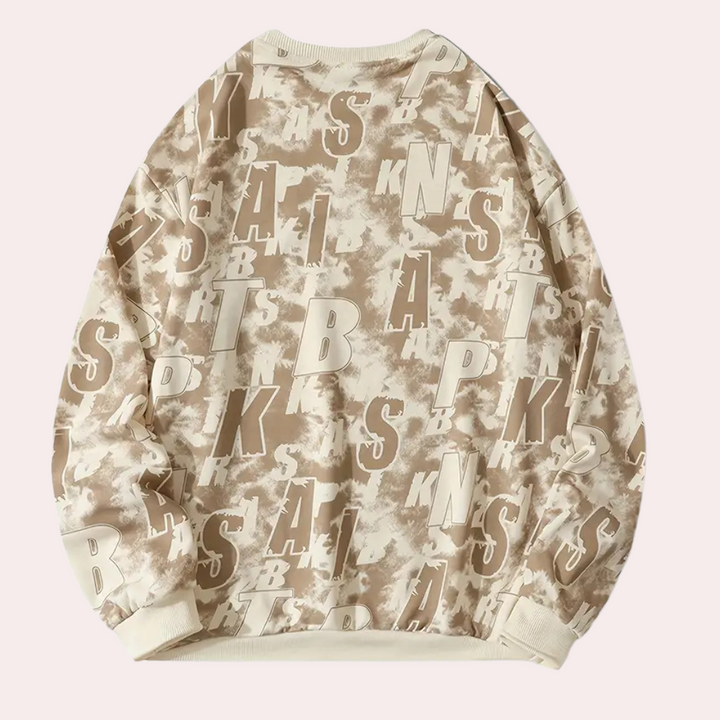 Beige oversized sweatshirt met abstracte camouflageprint en grote letters, trendy streetwear, unisex mode, comfortabele casual stijl.