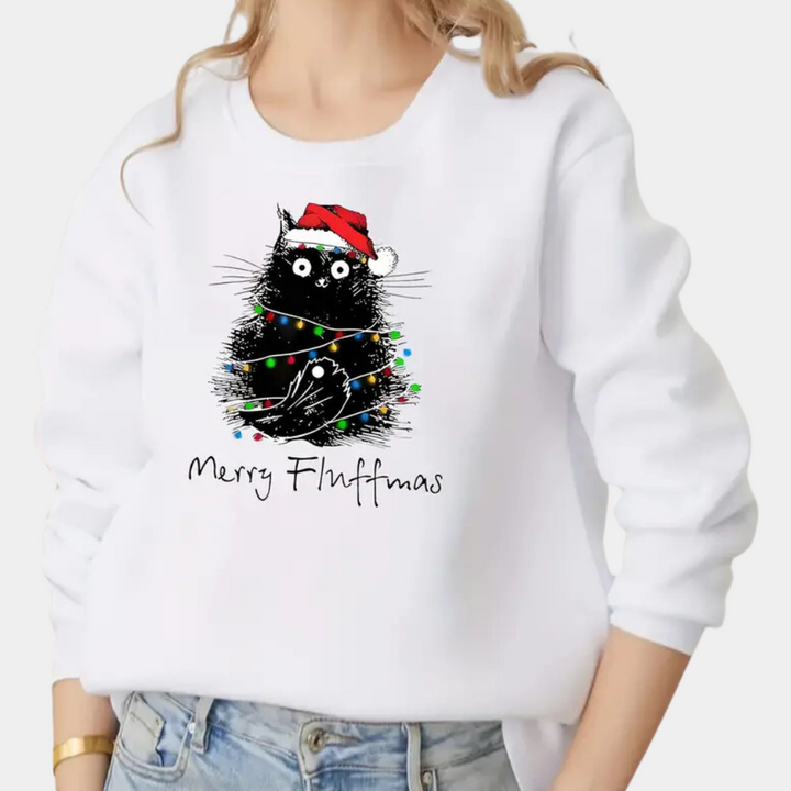 Vrouw draagt witte kersttrui met zwarte kat in kerstmanmuts en lichtjes, tekst "Merry Fluffmas". Perfect voor feestelijke kattenliefhebbers.