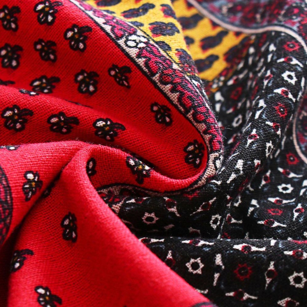 Heldere kleurrijke stof met bloemenpatroon, rood en zwart, gedetailleerd design, hoogwaardige textiel, modieuze print, decoratieve stof.