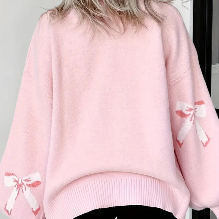 Roze trui met lange mouwen en strikmotief, damesmode, zachte stof, casual stijl, trendy kleding, comfortabele pasvorm, herfst-winter garderobe.