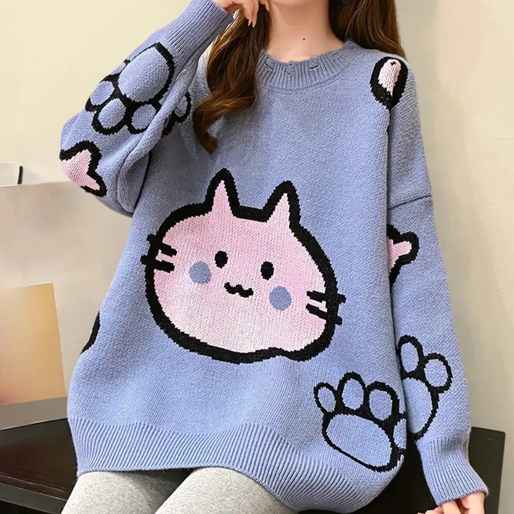 Blauwe trui met schattige kattenprint en roze pootafdrukken, perfect voor casual mode en kattenliefhebbers. Comfortabel en stijlvol ontwerp.
